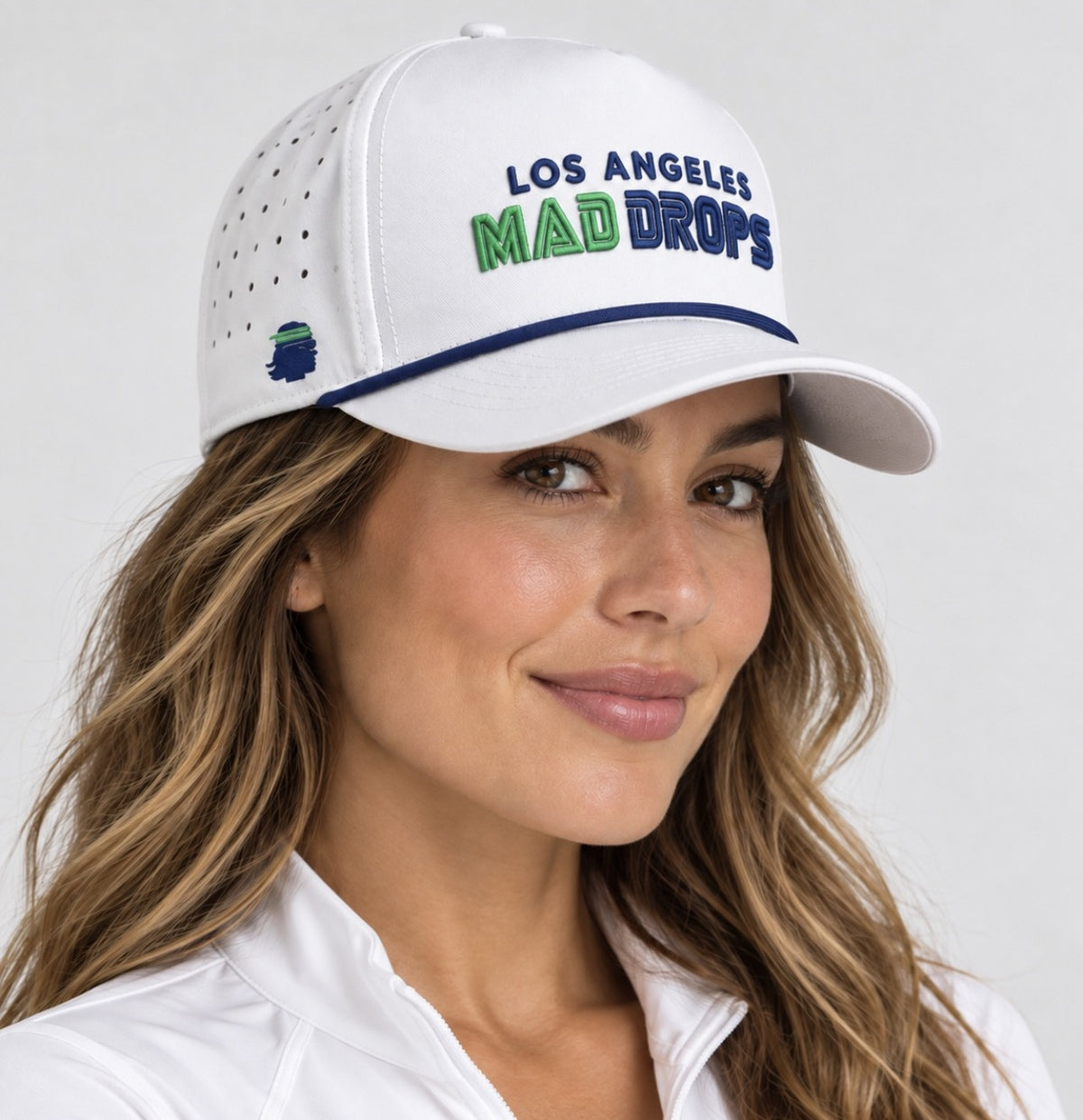 Coastline Classic Cap in white with navy and green Los Angeles Mad Drops embroidery and navy brim piping, worn by a model
